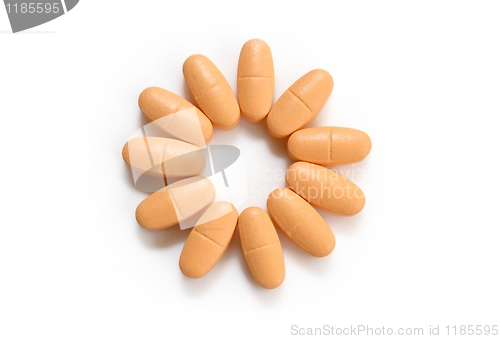 Image of orange pills over white