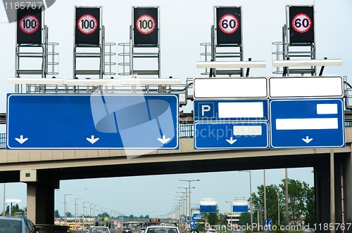 Image of Highway with many signs and traffic