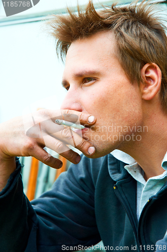 Image of Closeup of a young man with cigarette in mouth