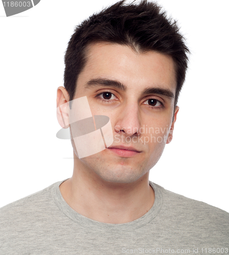 Image of Young man applying eye cream