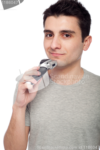 Image of Young man shaving