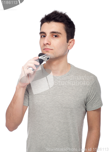 Image of Young man shaving