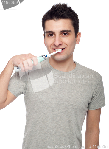 Image of Young man brushing teeth