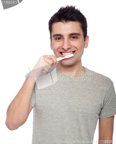 Image of Young man brushing teeth