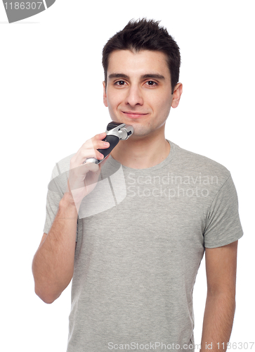 Image of Young man shaving