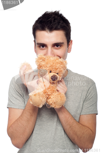 Image of Man cuddling teddy bear