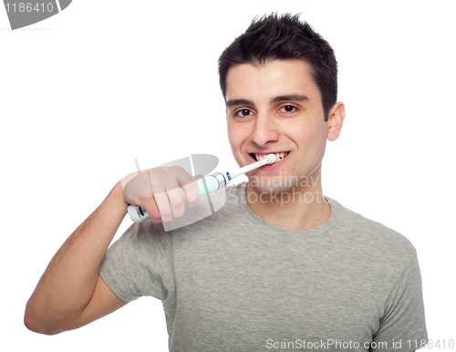 Image of Young man brushing teeth