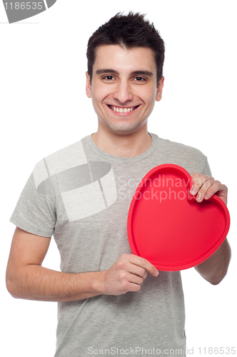 Image of Casual man holding heart