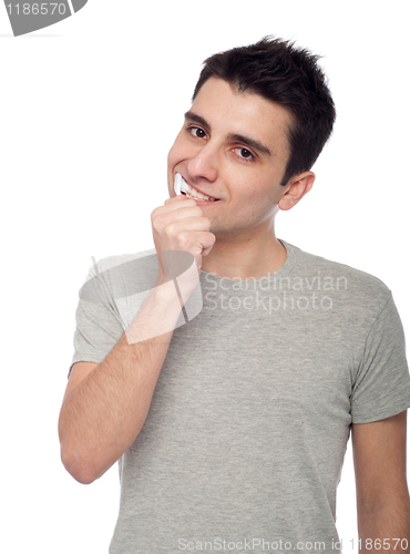 Image of Young man brushing teeth