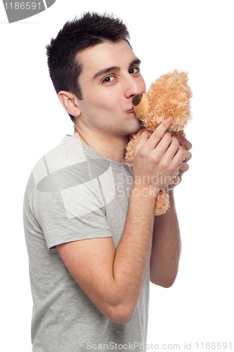 Image of Man kissing teddy bear