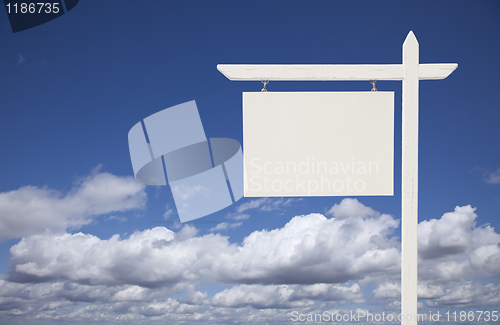 Image of Blank White Real Estate Sign Over Sky and Clouds