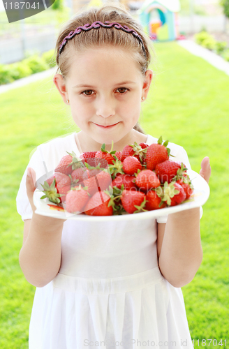 Image of Girl holding fresh strawberries