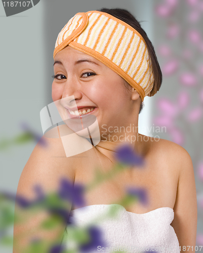 Image of Smiling Woman In Her Bedroom Getting Dressed