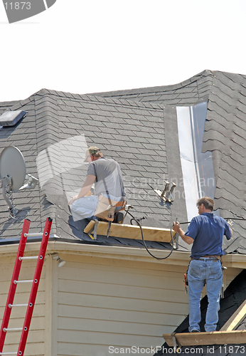 Image of Roofers - Two men lay a new roof down. Teamwork (12MP camera)