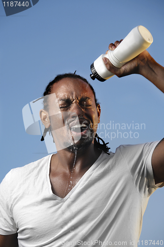 Image of Young athletic man taking a break 