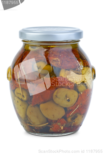 Image of Green greek olives conserved with dried tomato and cheese in the glass jar