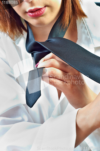 Image of Young business woman getting dressed up