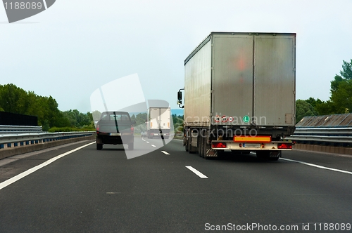 Image of Trucks traveling on highway delivering goods