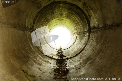 Image of An industrial tunnel leading into the light