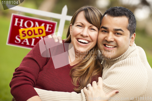 Image of Mixed Race Couple in Front of Sold Real Estate Sign