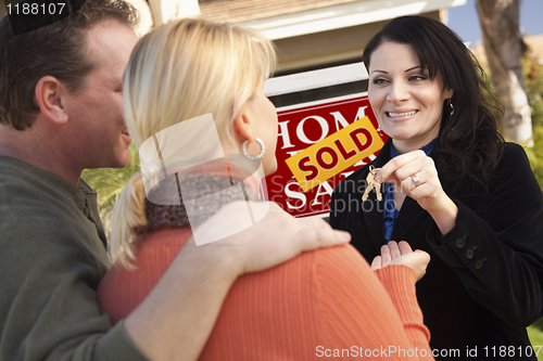 Image of Attractive Hispanic Female Real Estate Agent Handing Over Keys