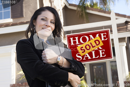 Image of Hispanic Woman in Front of Real Estate Sign and New Home