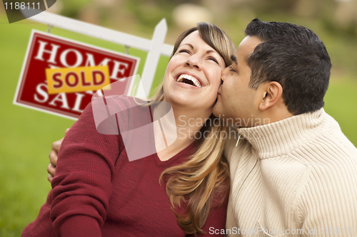 Image of Mixed Race Couple in Front of Sold Real Estate Sign