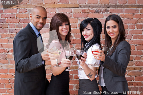 Image of Smiling young people with glasses of wine