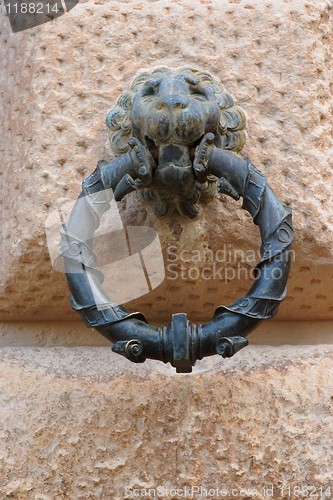 Image of Lion head holding a ring on Carlos V palace in Granada