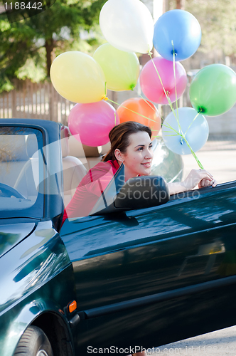 Image of Beautiful brunette woman in car