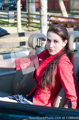 Image of Beautiful brunette woman in car