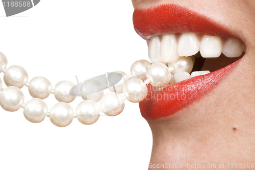 Image of woman smiles showing white teeth and pearly necklace