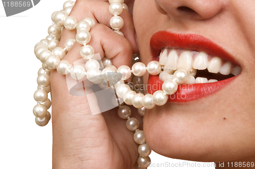 Image of woman smiles showing white teeth and pearly necklace