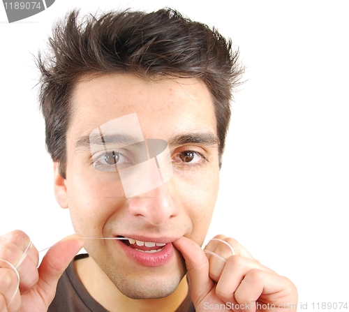Image of Man flossing his teeth