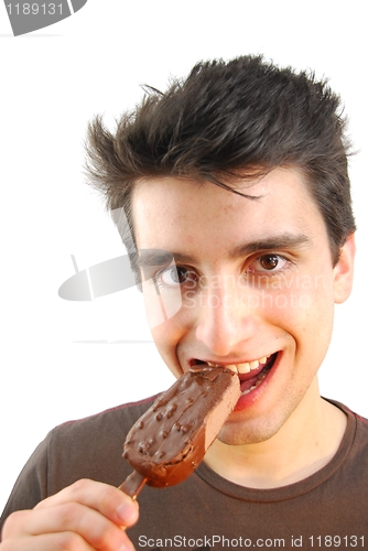 Image of Portrait of a cute young man eating an ice-cream