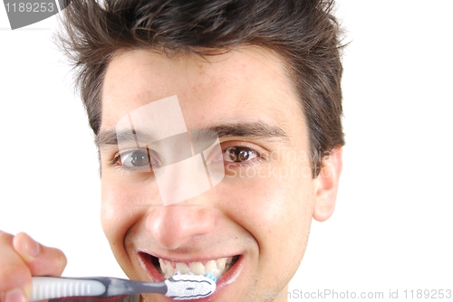 Image of Cute guy washing his teeth