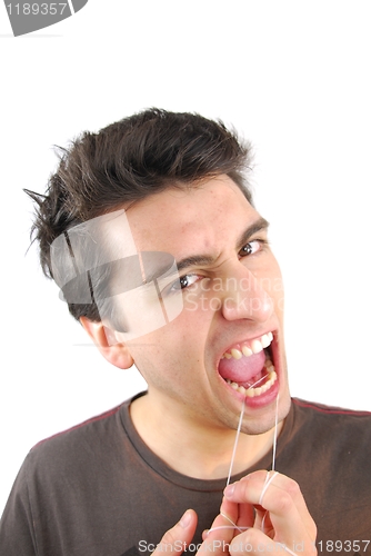 Image of Man flossing his teeth (NO expression)