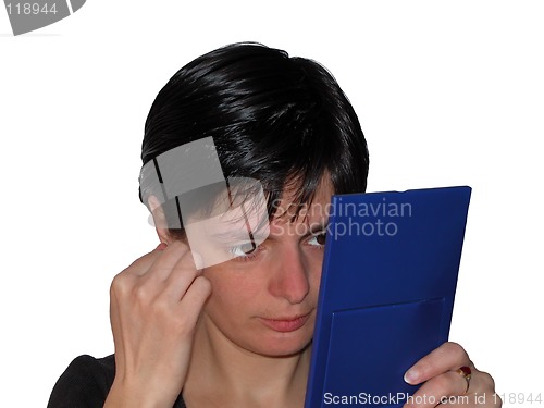 Image of Woman using a mirror