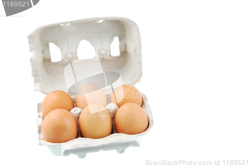 Image of Six brown eggs packed in a carton box