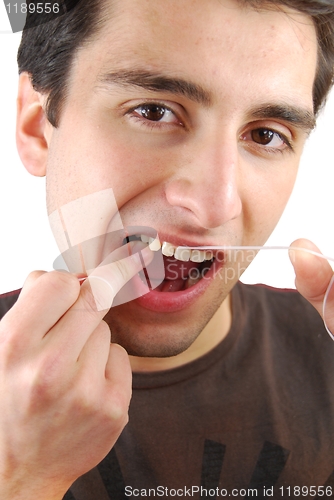 Image of Man flossing his teeth