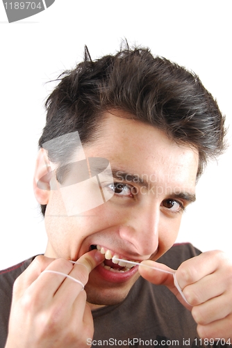 Image of Man flossing his teeth