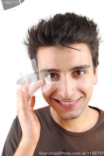 Image of Smiling man applying eye cream