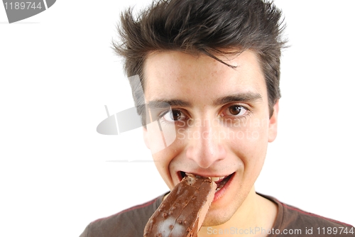 Image of Portrait of a cute young man eating an ice-cream