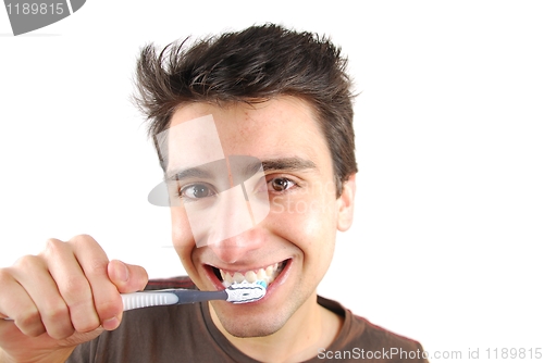 Image of Cute guy washing his teeth