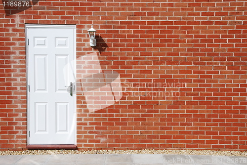 Image of White door on a brick wall