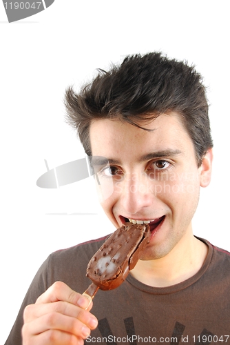 Image of Portrait of a cute young man eating an ice-cream
