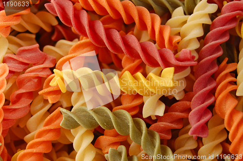 Image of multi colored twirls pasta background