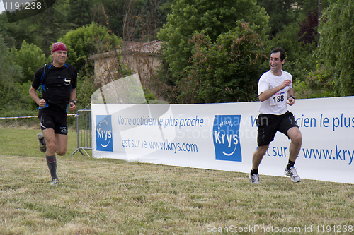 Image of two runners next to the finishline