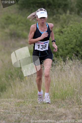 Image of Woman running with a cap