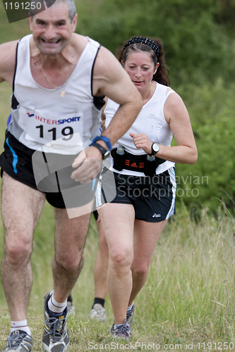 Image of Woman running behind a man 